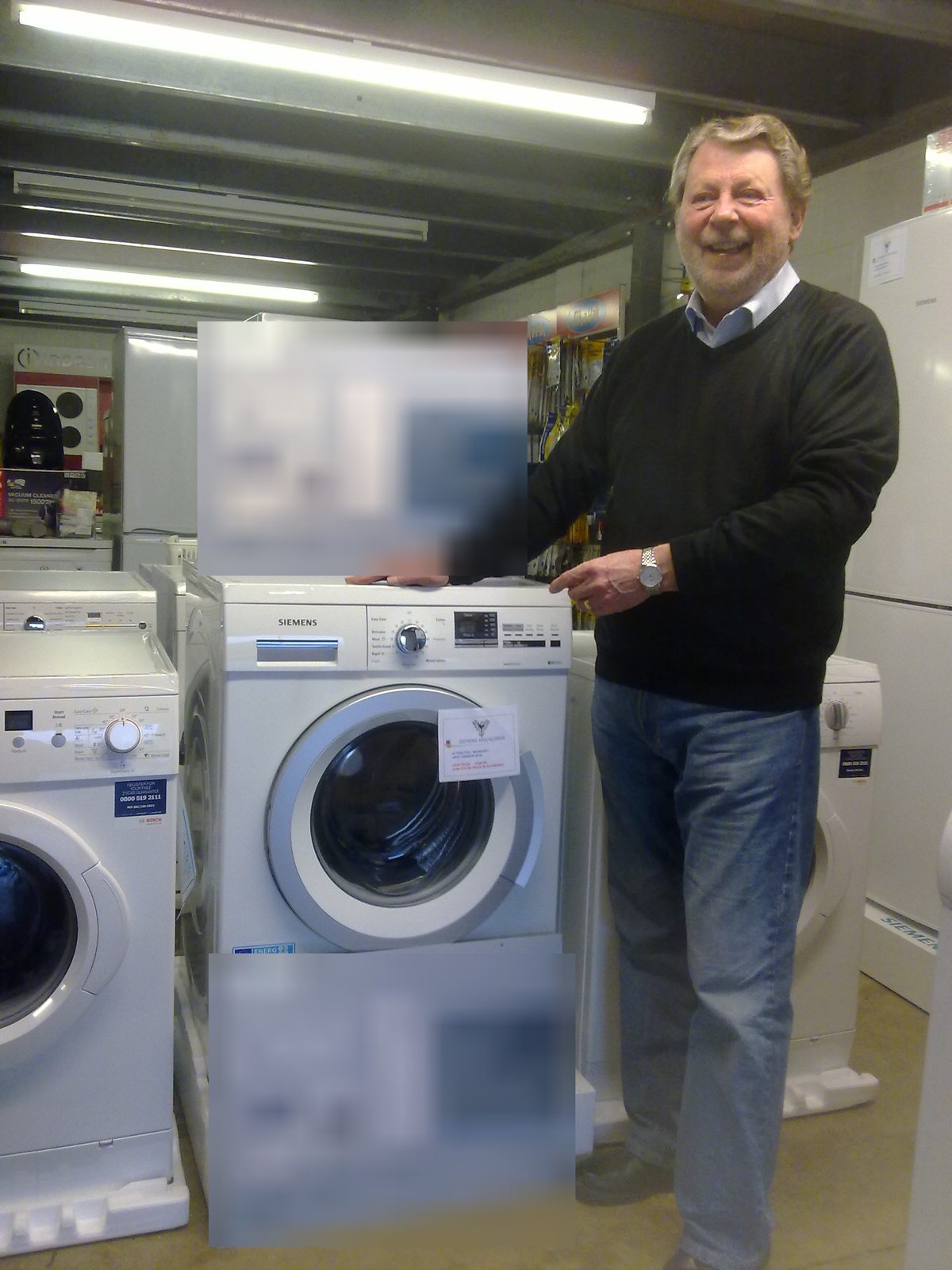 Standing beside a Siemens washing machine on the shop floor