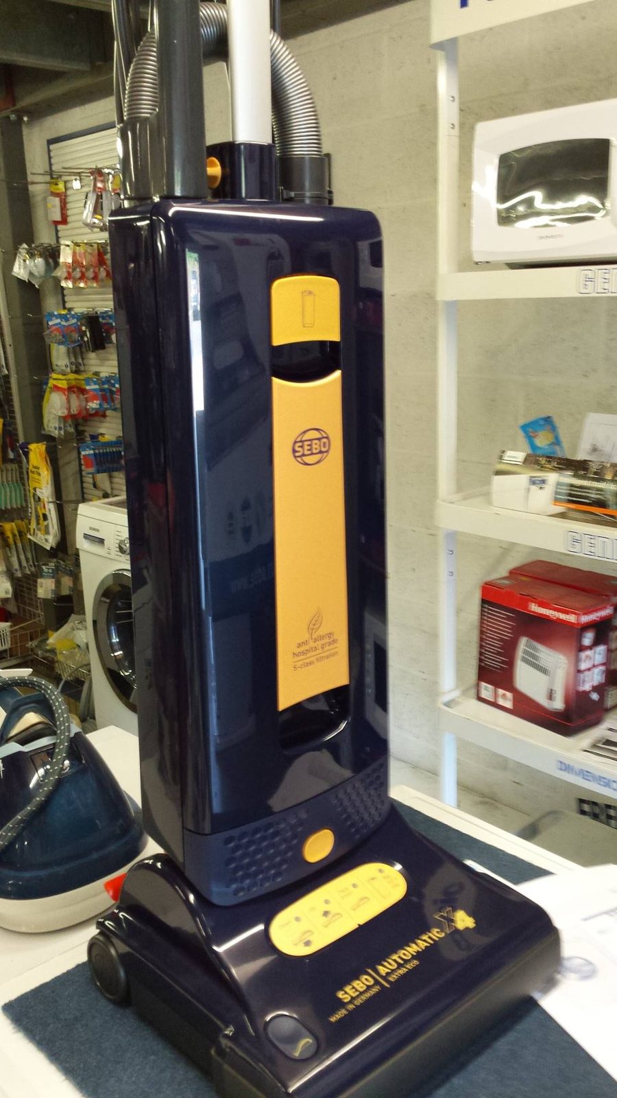 A Sebo upright vacuum cleaner on display in the shop